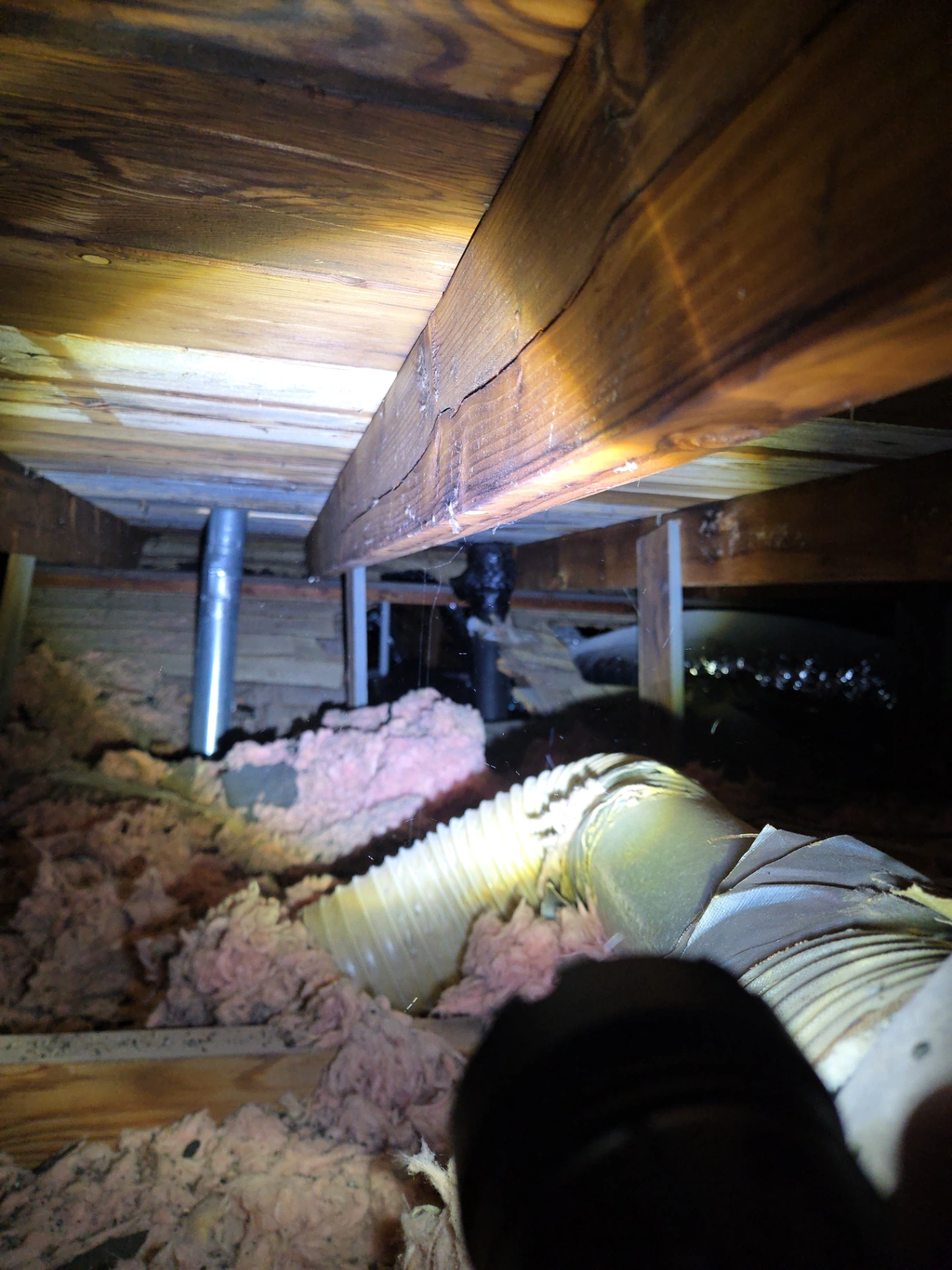 Attic repair inspecting damaged insulation and ductwork in Stillwater, OK